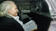 Peter Nygard arrives in a vehicle during his sexual assault trial in Toronto. The former fashion executive has been sentenced to 11 years in prison.