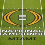 A wide shot of the College Football Playoff logo displayed prominently before a championship game.