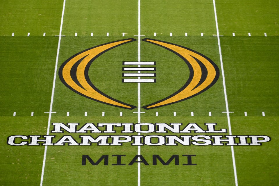 A wide shot of the College Football Playoff logo displayed prominently before a championship game.