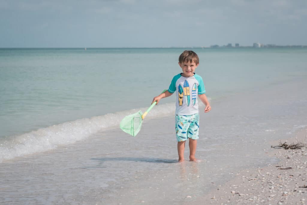 Kid enjoying the beach in Pass-a-Grille, St. Pete Beach, Florida