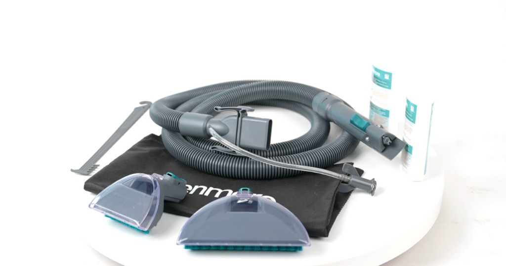 A collection of carpet shampooer attachments including hoses and various cleaning heads, essential for pet owners to tackle stains on different surfaces like upholstery and stairs.