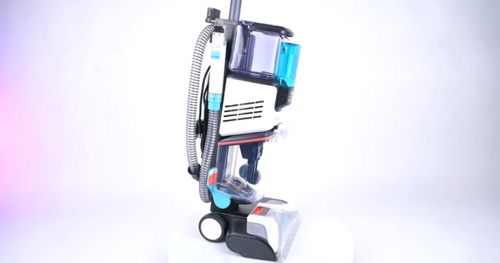 A side view of the Shark CarpetXpert carpet cleaner, showcasing its onboard hose for quick and convenient access, a key feature for pet owners dealing with frequent pet messes.