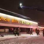 Image of firefighters responding to Uncle Bill's Pet Center fire at night