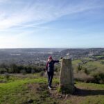 Edita at the summit trig pillar on Little Solsbury Hill with the city of Bath below. Her heart is going boom boom boom.