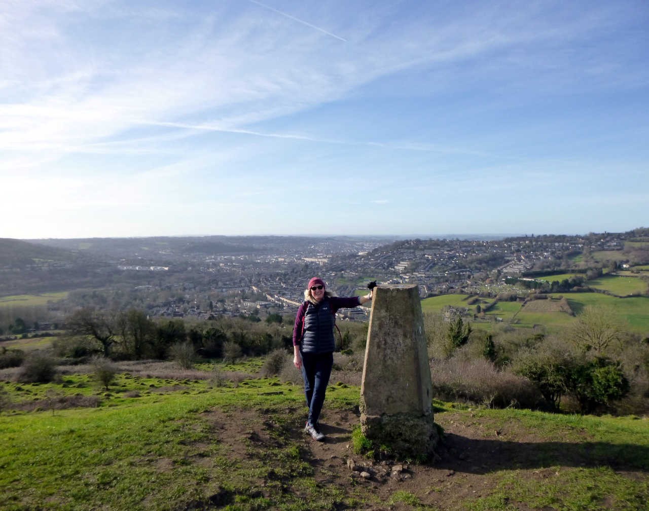 Edita at the summit trig pillar on Little Solsbury Hill with the city of Bath below. Her heart is going boom boom boom.