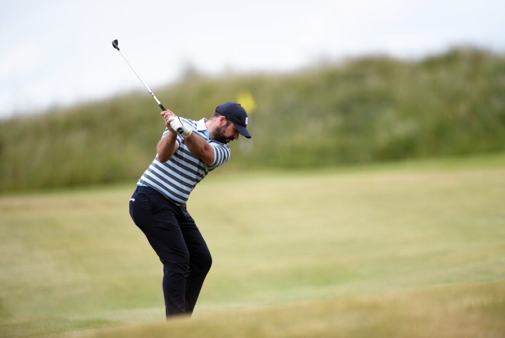 Peter Finch in action, demonstrating his golf swing on the fairway, during a regional qualifying event.