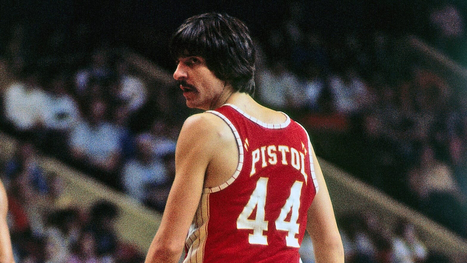 Pete Maravich in action, showcasing his ball-handling skills and signature style