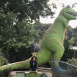 Iconic T-Rex statue at Peter Pan Mini Golf in Austin, Texas, a beloved roadside attraction.