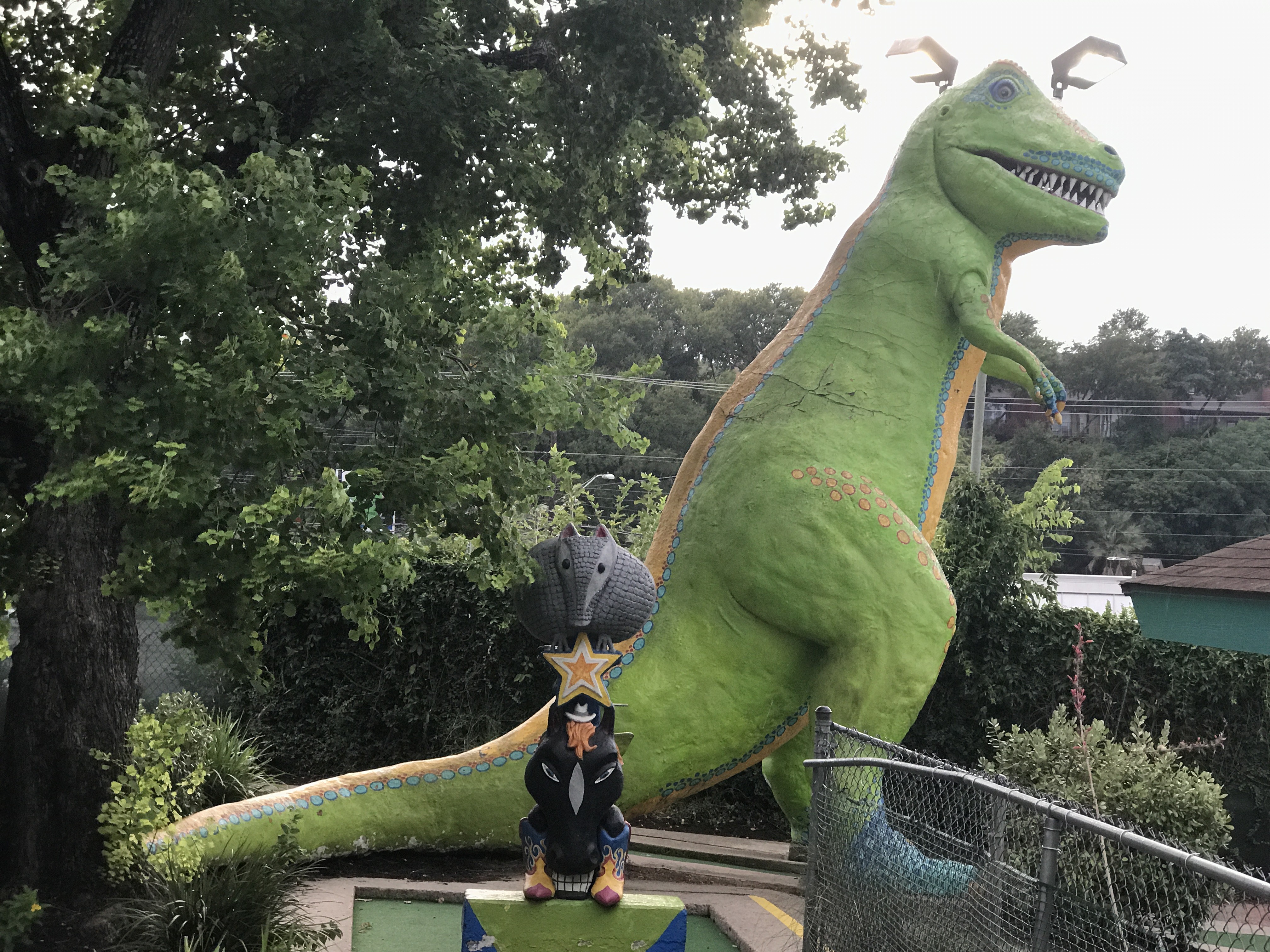 Iconic T-Rex statue at Peter Pan Mini Golf, a beloved Austin, Texas landmark, welcoming visitors to enjoy classic mini golf fun.