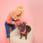 Dolly Parton smiling and wearing a denim jacket