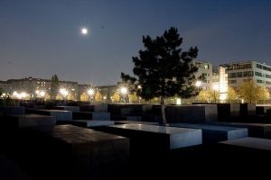 Night view of the Memorial to the Murdered Jews of Europe, emphasizing the grid-like structure and somber atmosphere