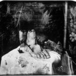 Joel-Peter Witkin's Still Life with Mirror, a 2003 photograph showcasing his signature macabre and surreal style.