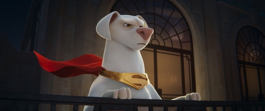 Krypto the Super-Dog, a white dog wearing a red cape and collar, standing heroically.