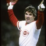 Pete Rose salutes the crowd after breaking Ty Cobb's hit record, showcasing his connection with fans.