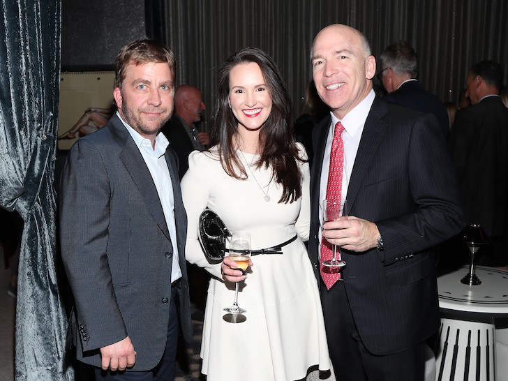 Peter Billingsley, Buffy Bains, and David Barr smiling holding champagne glasses at a gala