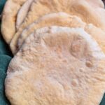 Baked pita bread in kitchen towel