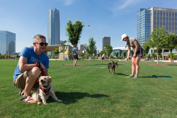 People enjoying time with dogs at Scissortail Park in Oklahoma City