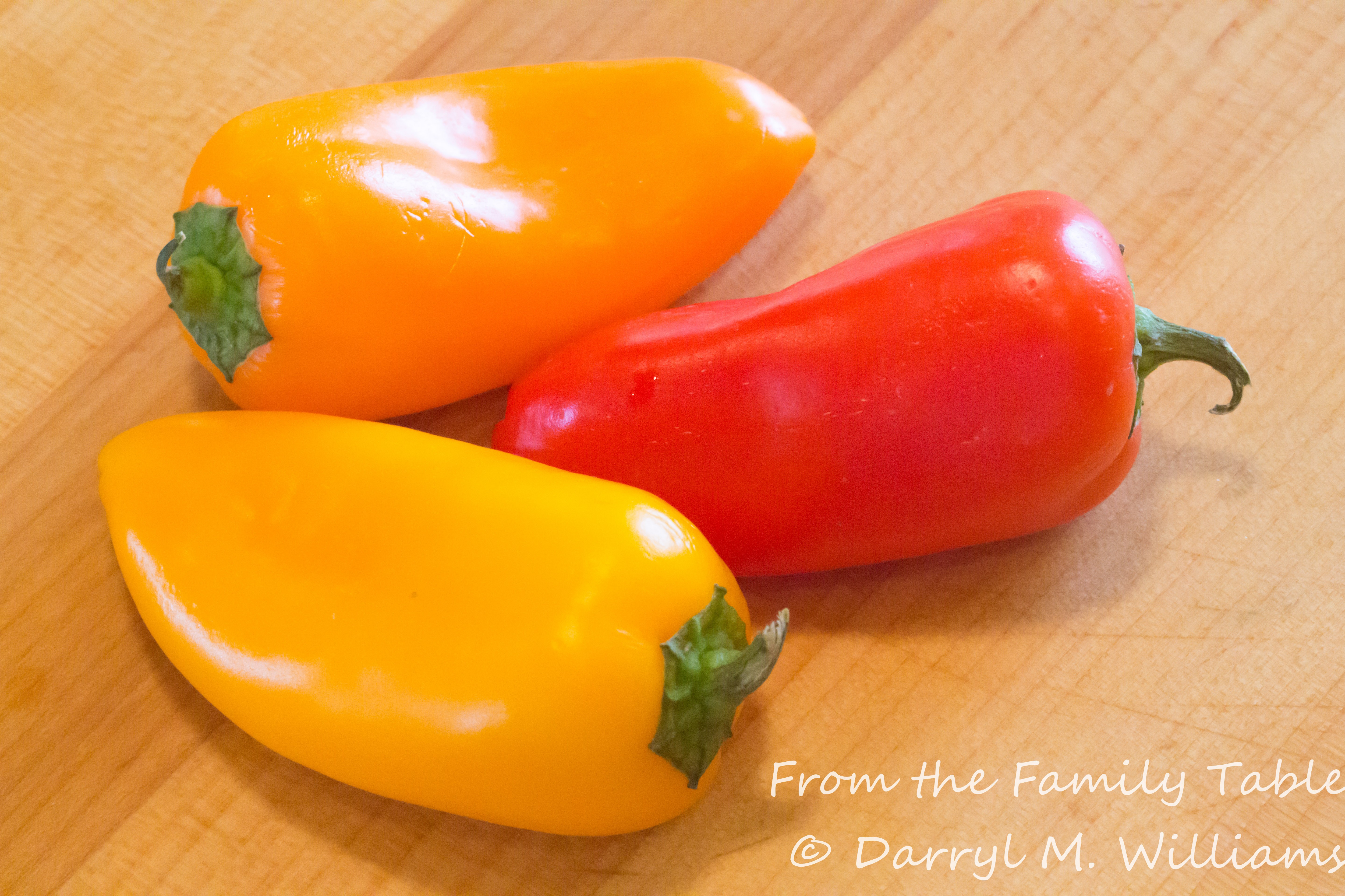 Red, orange, and yellow miniature bell (snacking) peppers, showcasing the vibrant ingredients for the crab stuffing.