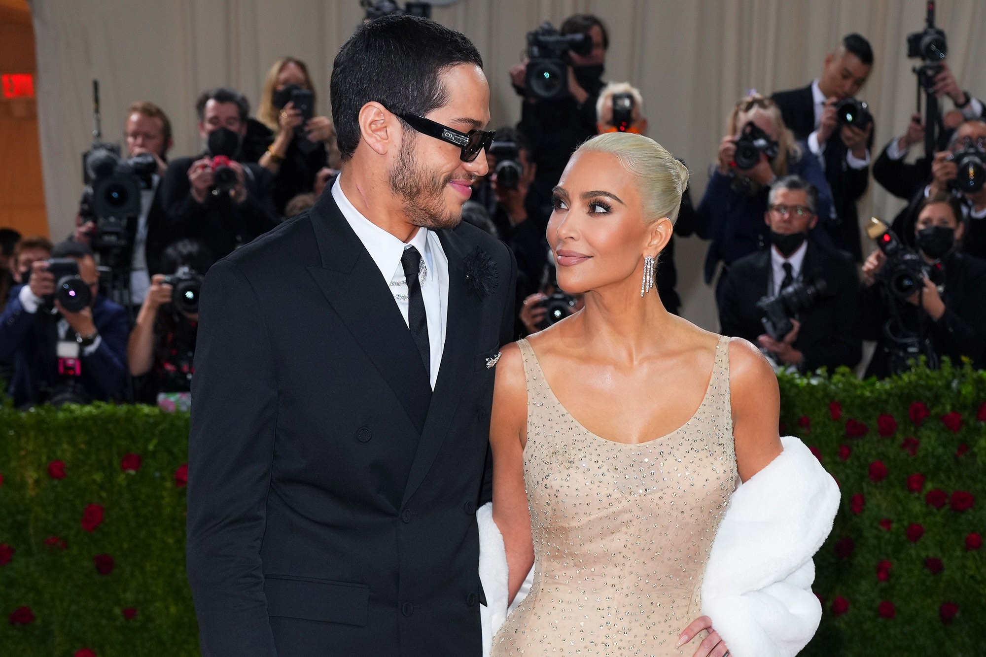 Pete Davidson and Kim Kardashian, walking side by side, photographed in 2021